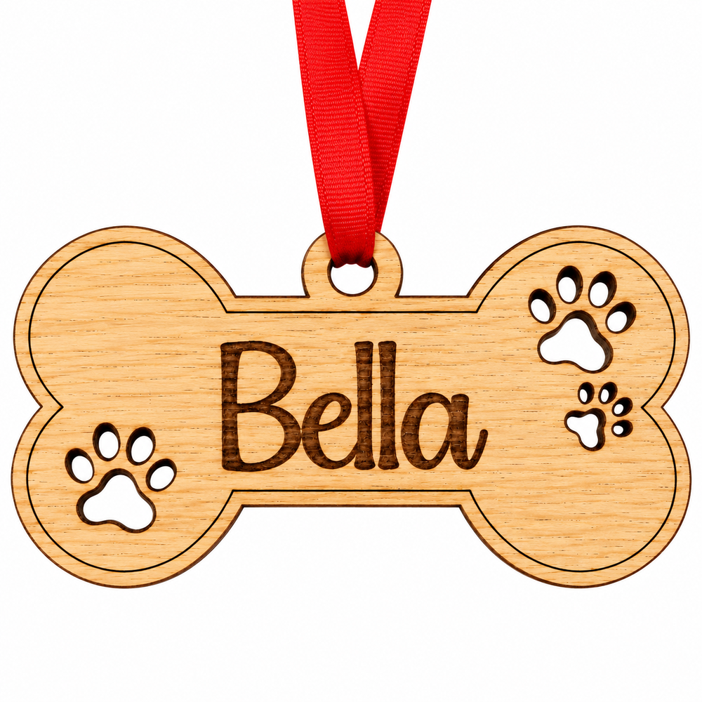 A personalized wooden bone-shaped pet ornament engraved with the name 'Bella' and paw prints, hanging from a red ribbon on a white background.