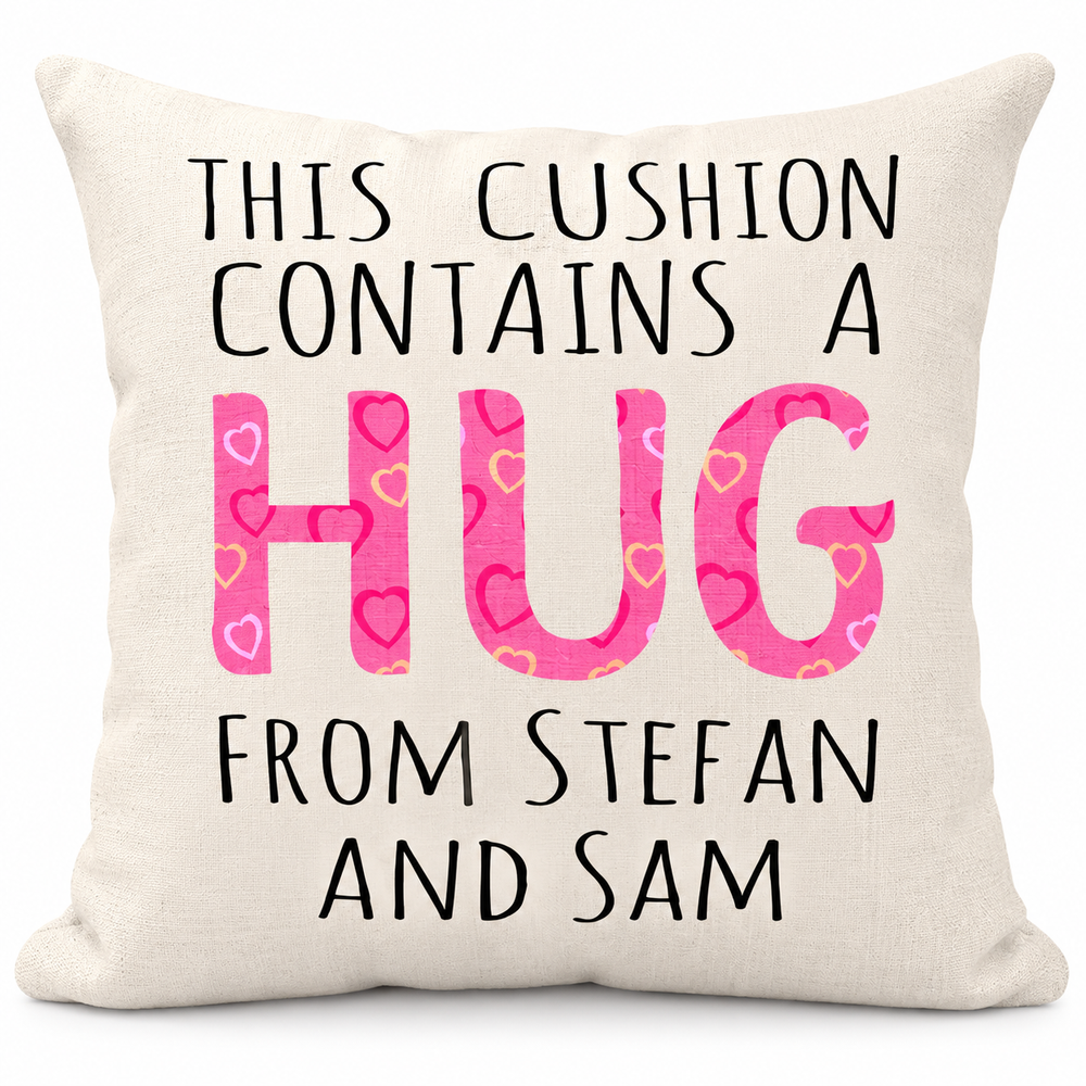 A square cream-colored throw pillow with a humorous printed message. The text reads 'THIS CUSHION CONTAINS A HUG FROM STEFAN AND SAM' in black lettering, with the word 'HUG' filled with a pink pattern of small hearts in various shades.