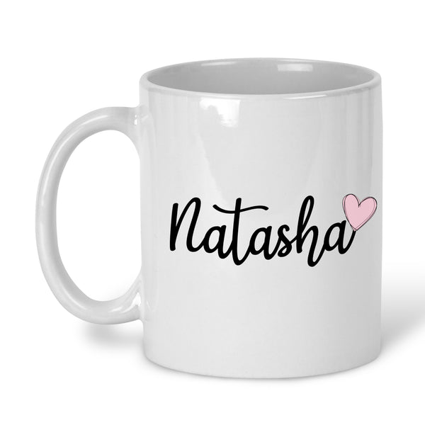 A white ceramic mug with a personalised name in black script and a pink heart symbol below the text.